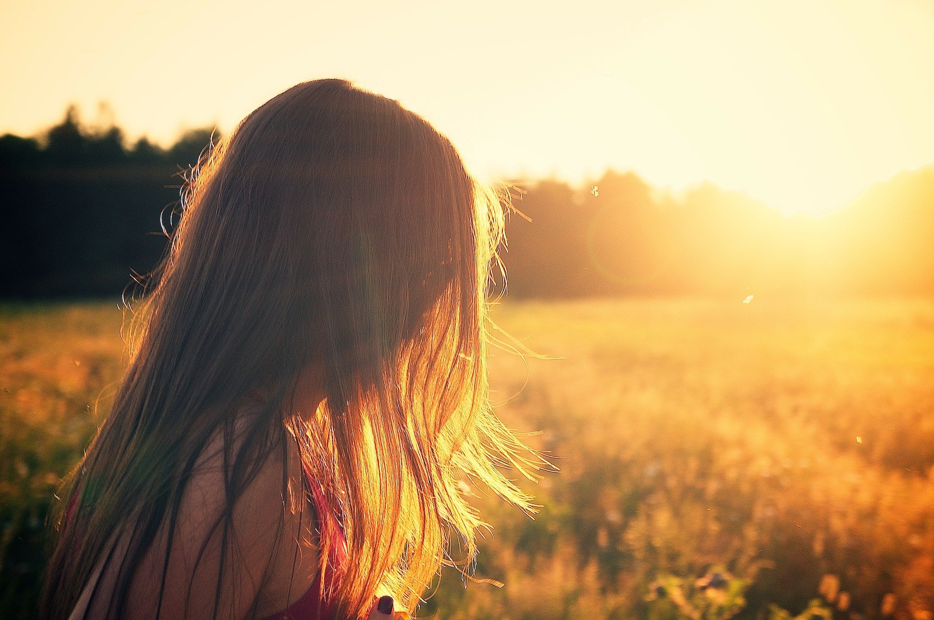 Woman Standing in a Sun Lit Field